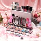 Silver makeup case displayed with lipsticks, brushes and eyeshadows