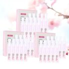 Three boxes of sakura hydrating serum ampoules on a light pink background