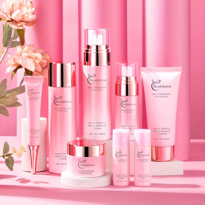 Hydrating face care set with toner, lotion, essence and cream on a pink background