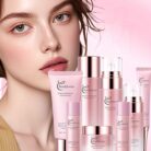 Woman with glowing skin next to the pink face care products